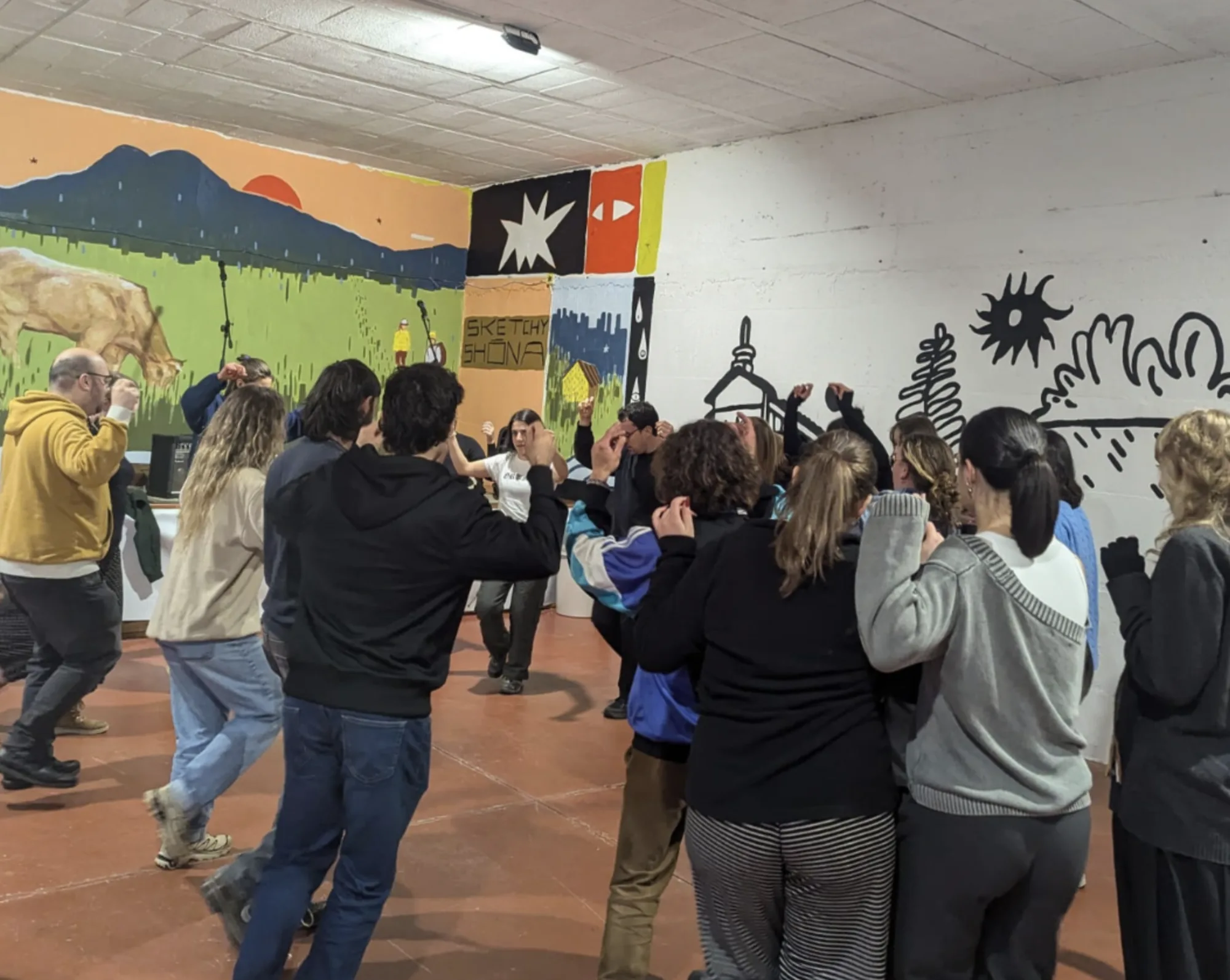 Artists and visitors inside the Rural Hackers mural project in Anceu, Galicia